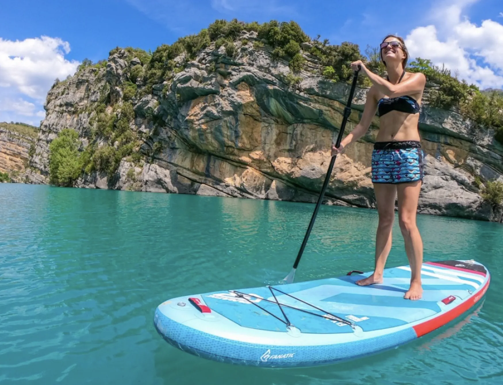 Paddle sur l'eau turquoise du lac de Castillon au pied des falaises
